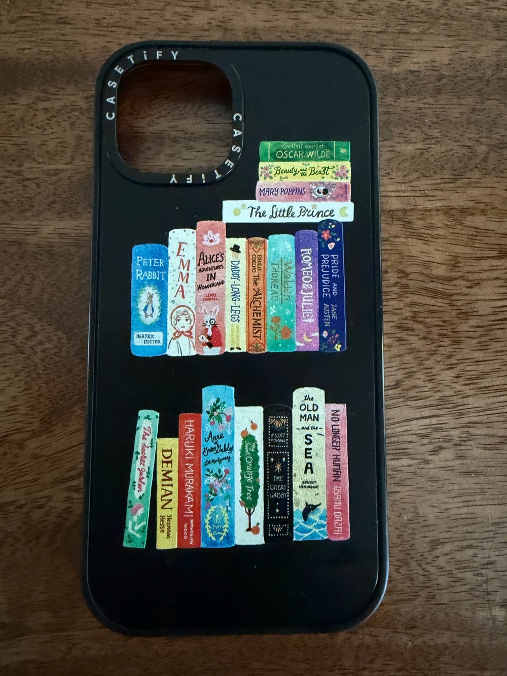 Casetify Black iPhone 15 Case with Colorful Stacked Books Artwork